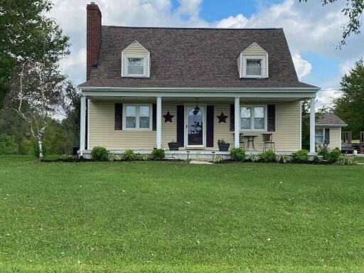 cape cod house featuring a front lawn