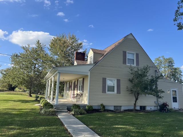 exterior space featuring covered porch and a front lawn