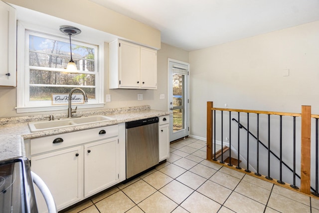 kitchen featuring light countertops, white cabinets, dishwasher, and a sink