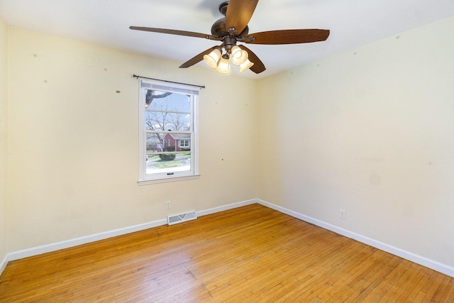 unfurnished room with baseboards, visible vents, ceiling fan, and light wood finished floors