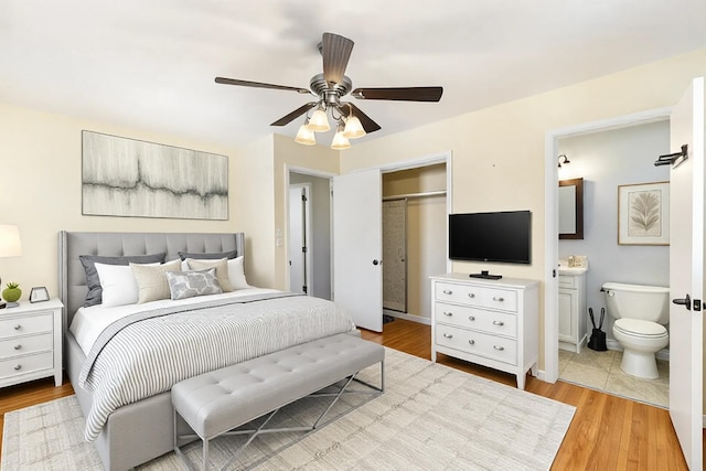 bedroom with a ceiling fan, a closet, light wood finished floors, and ensuite bathroom