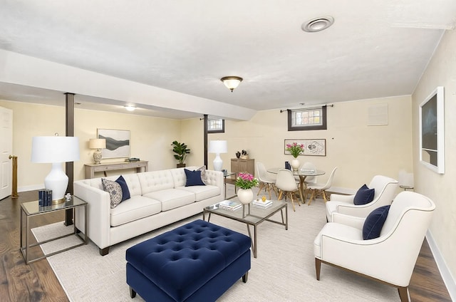 living area with baseboards and wood finished floors