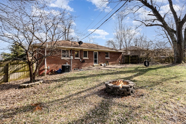 back of property featuring brick siding, an outdoor fire pit, cooling unit, and fence