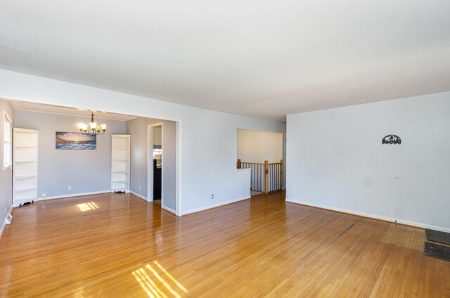 living room featuring wood-type flooring, a wealth of natural light, and a chandelier