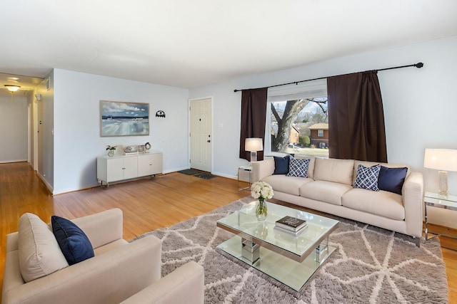 living room featuring baseboards and wood finished floors