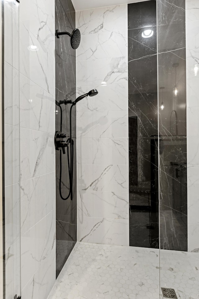 full bath with a marble finish shower