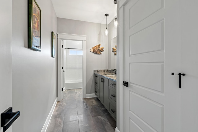 full bathroom featuring baseboards, tub / shower combination, and vanity