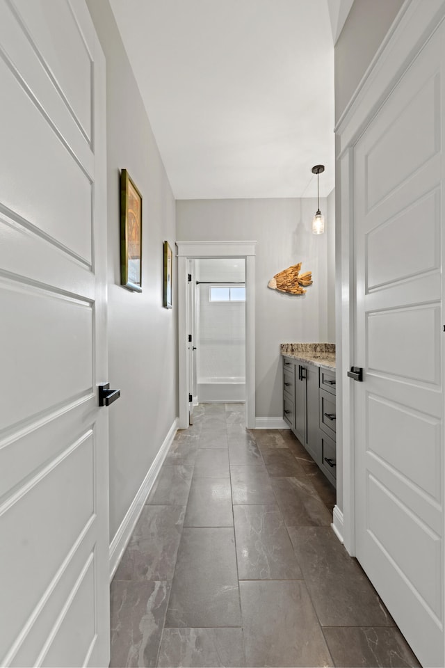 interior space with baseboards and vanity