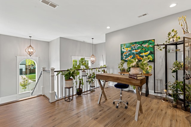 office space with recessed lighting, wood finished floors, visible vents, and an inviting chandelier