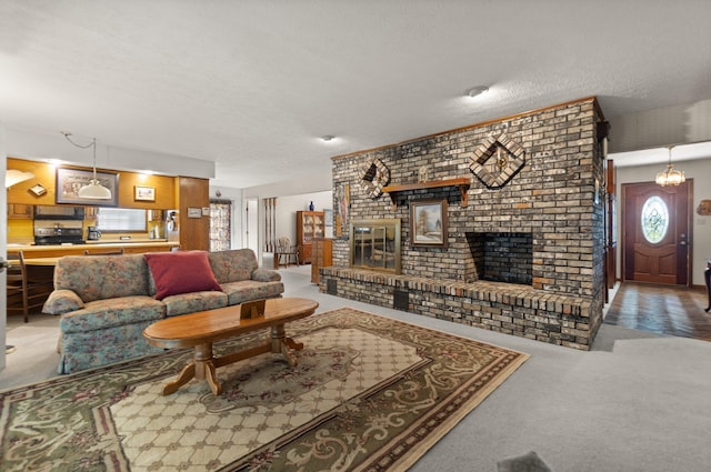 carpeted living room with a textured ceiling and a brick fireplace