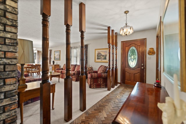 carpeted foyer entrance featuring a notable chandelier