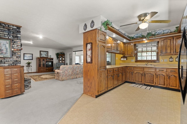 kitchen featuring light carpet, stainless steel refrigerator, sink, and ceiling fan