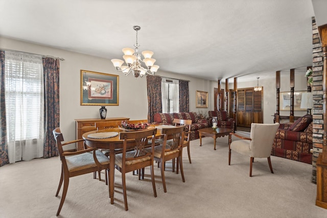 dining space with an inviting chandelier and light carpet