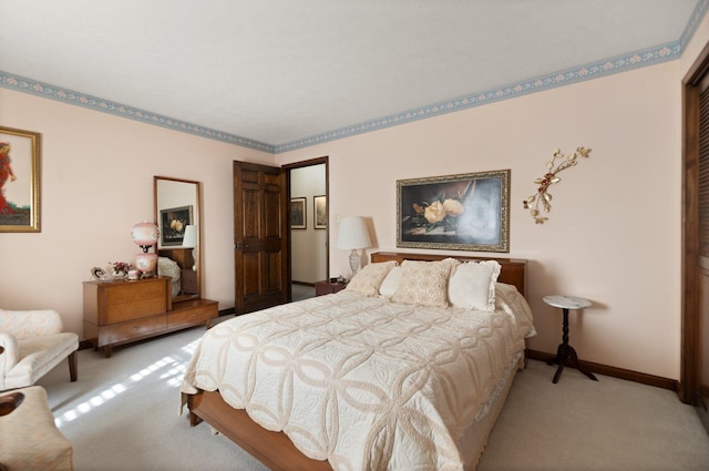 bedroom with light colored carpet and a closet