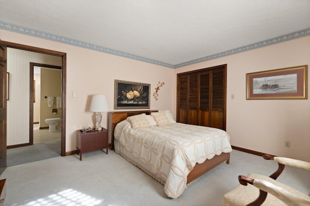 carpeted bedroom featuring ensuite bath and a closet