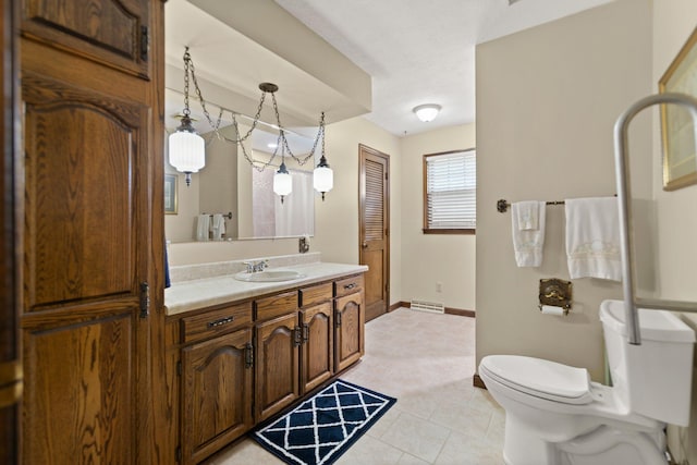 bathroom featuring vanity, toilet, and tile patterned floors