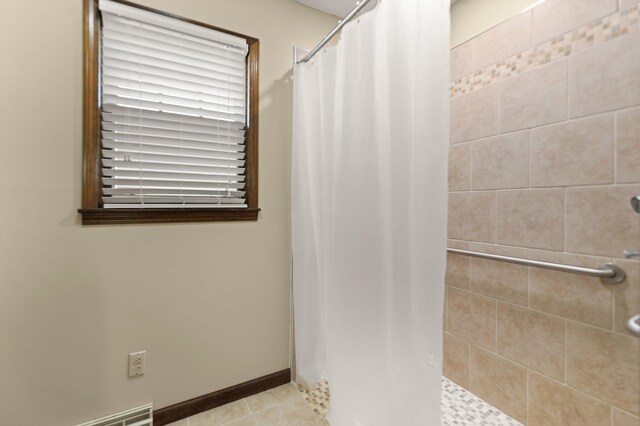 bathroom with tile patterned floors and curtained shower