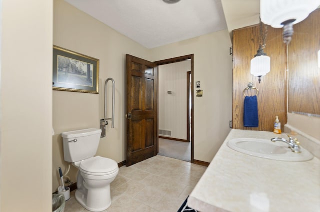 bathroom featuring tile patterned floors, vanity, and toilet