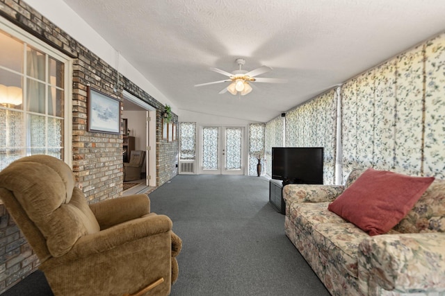 carpeted living room with ceiling fan, a textured ceiling, and lofted ceiling