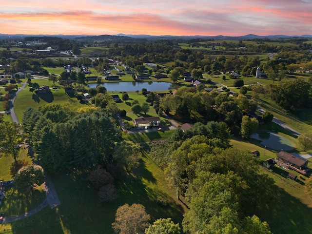 aerial view at dusk with a water view