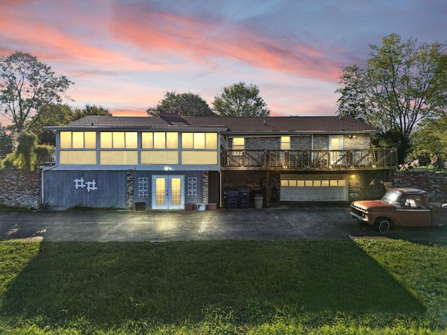 exterior space featuring a yard, a wooden deck, and french doors