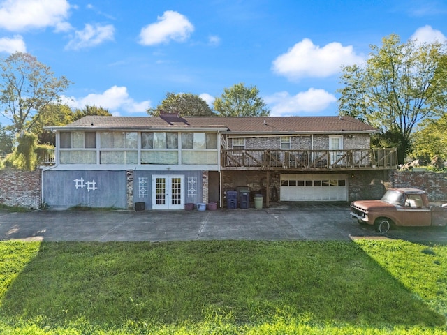 view of front of house with a deck, a front yard, and french doors