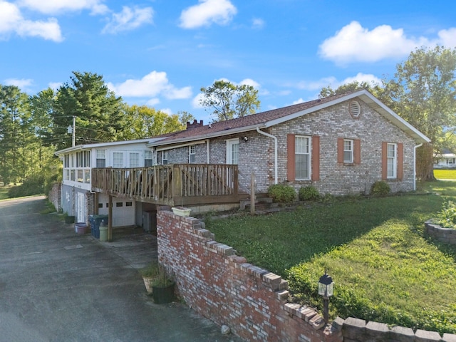 view of front of home with a front yard and a deck