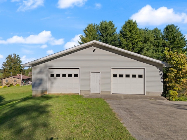 garage featuring a lawn