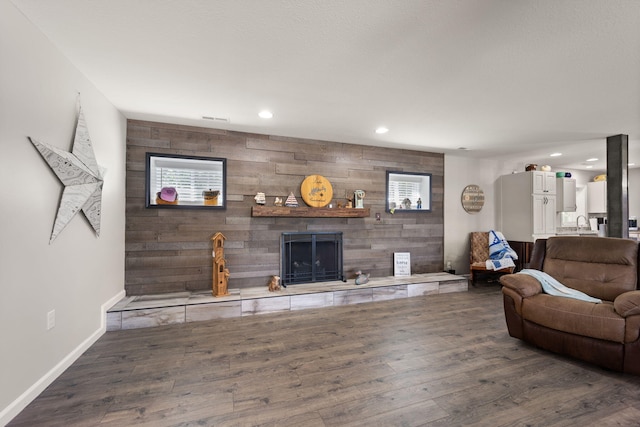 living room with wood walls and hardwood / wood-style floors