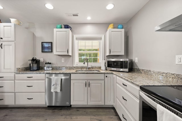 kitchen featuring white cabinets, stainless steel appliances, dark hardwood / wood-style floors, and sink