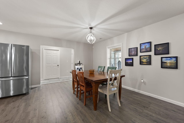 dining room with an inviting chandelier and dark hardwood / wood-style flooring