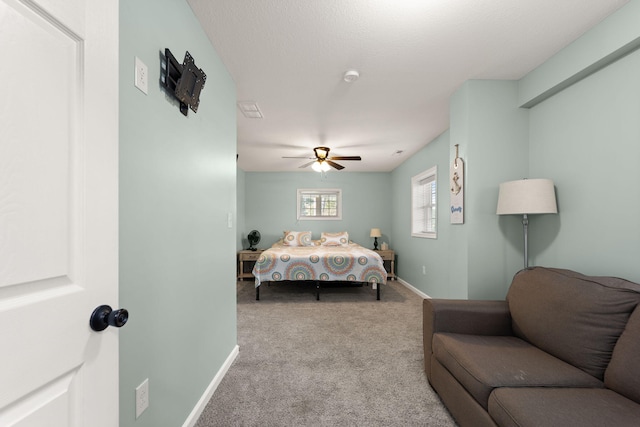 bedroom with ceiling fan and light colored carpet