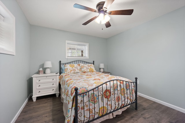 bedroom with dark hardwood / wood-style flooring and ceiling fan