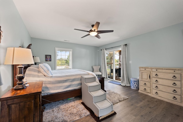 bedroom with ceiling fan, dark wood-type flooring, and access to exterior