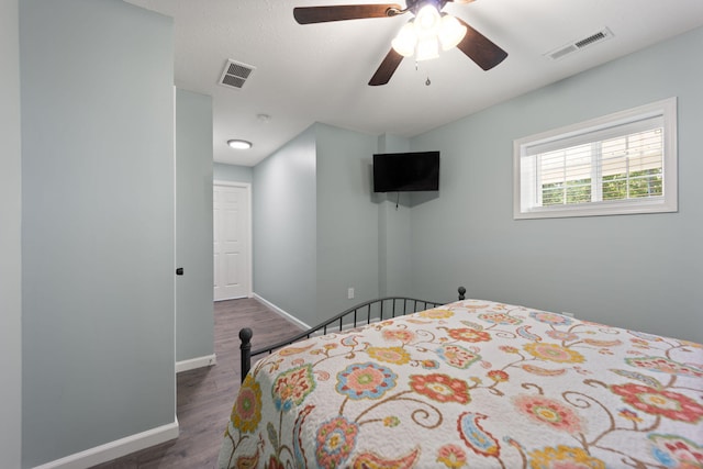 bedroom featuring ceiling fan and dark hardwood / wood-style flooring