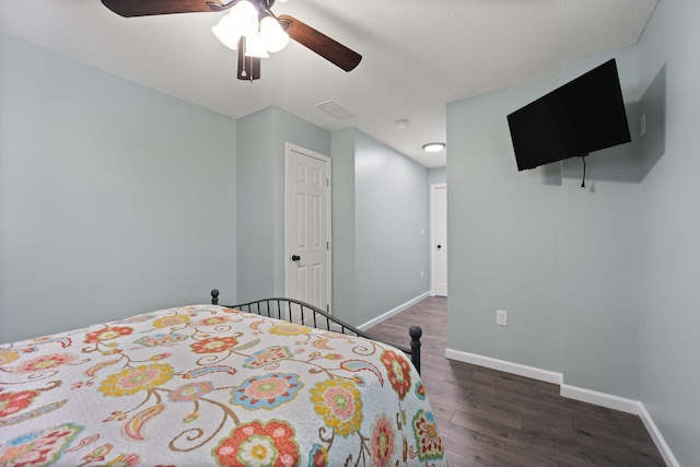 bedroom featuring ceiling fan and dark hardwood / wood-style flooring