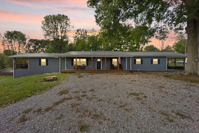 single story home with a porch