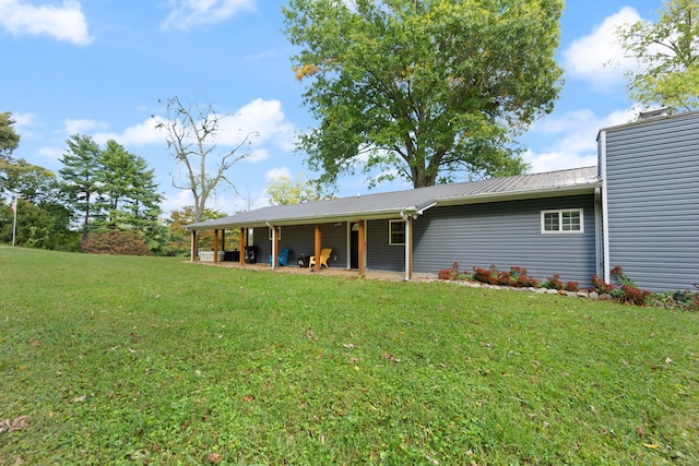 rear view of house with a yard