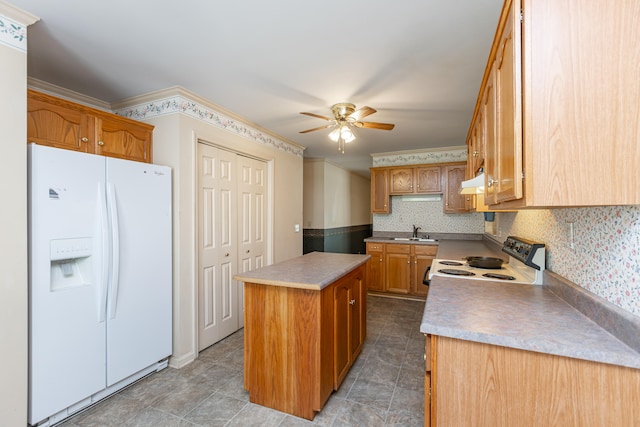 kitchen with ceiling fan, sink, white appliances, a kitchen island, and crown molding