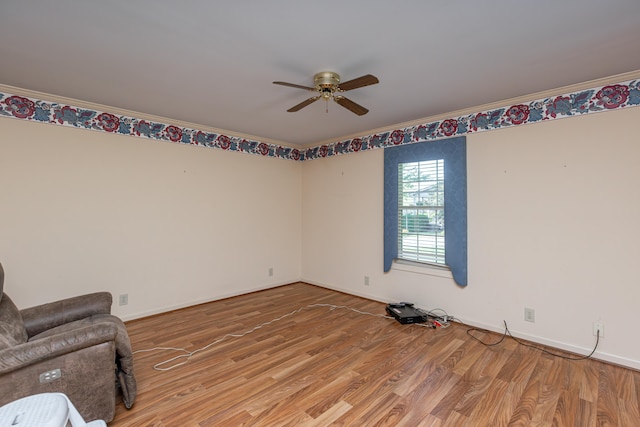 interior space featuring ceiling fan, crown molding, and hardwood / wood-style floors