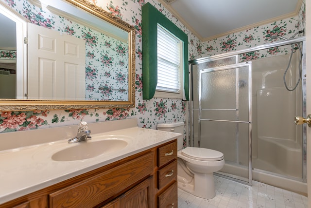 bathroom with crown molding, vanity, toilet, and a shower with door