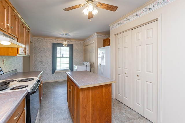 kitchen featuring ceiling fan, pendant lighting, white appliances, a kitchen island, and washer and dryer