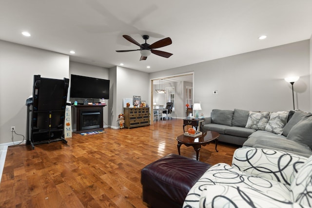 living room featuring ceiling fan and wood-type flooring