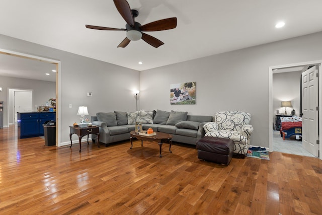 living room featuring light hardwood / wood-style flooring and ceiling fan