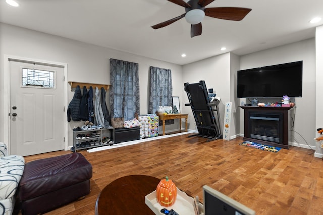 living room with hardwood / wood-style floors and ceiling fan