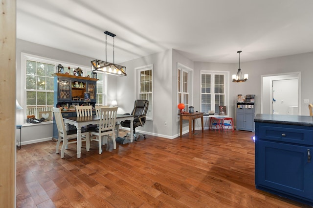 dining area featuring dark hardwood / wood-style flooring and a notable chandelier