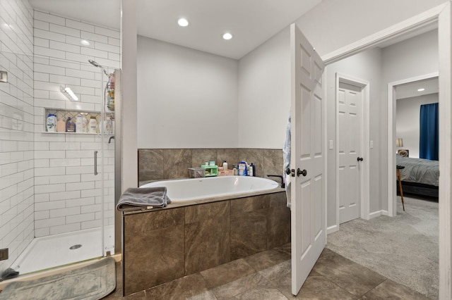 bathroom with tile patterned flooring and separate shower and tub