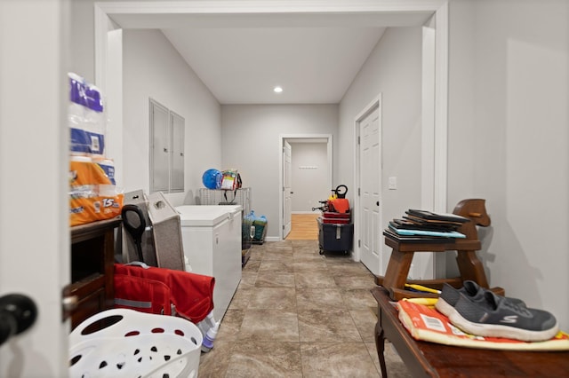 clothes washing area with washing machine and dryer