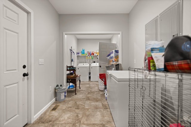 clothes washing area with washer and clothes dryer