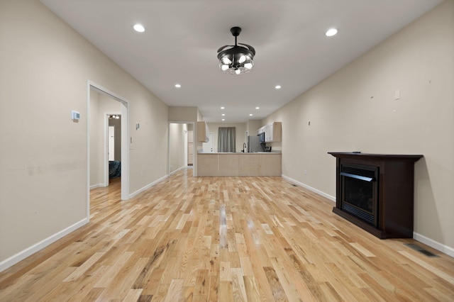 unfurnished living room with light hardwood / wood-style flooring